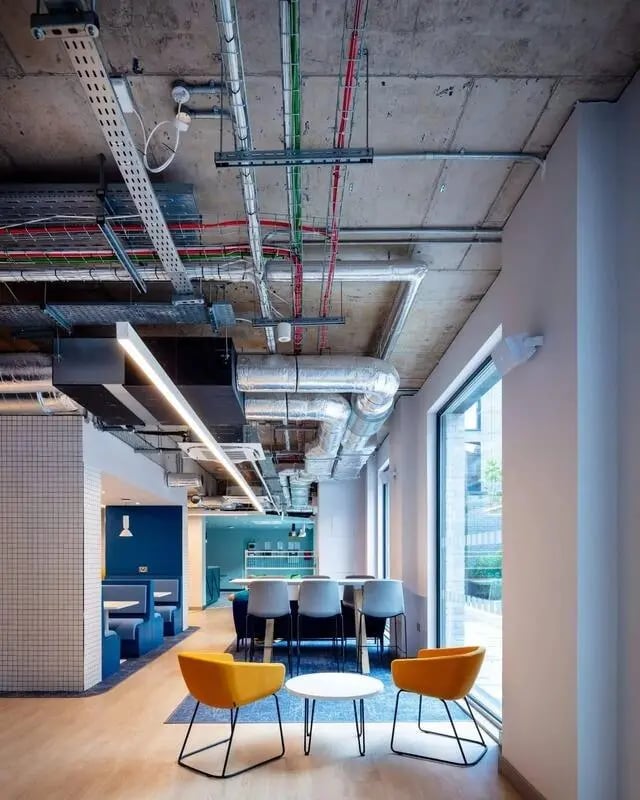 Orange chairs and tables communal area lounge at Coleman Court in Cork Student Accommodation