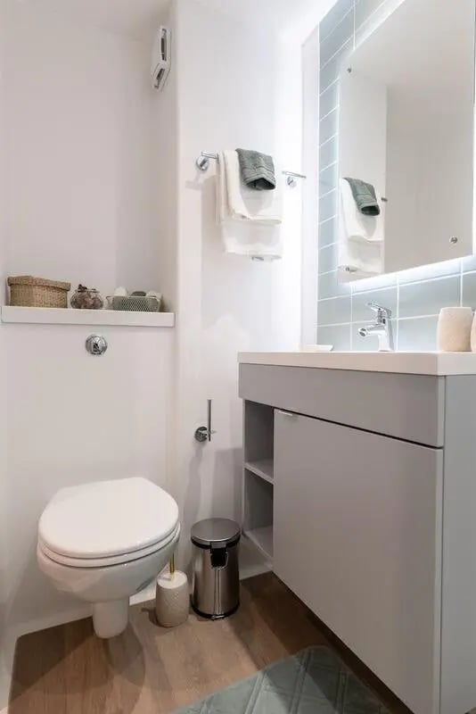 Toilet sink trash bin shelf with baskets bathroom at The Artisan in Dublin Student Accommodation