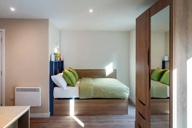 Bed with green pillows and mirrored wardrobe bedroom at The Artisan in Dublin Student Accommodation