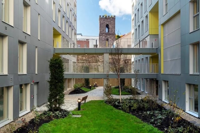 Courtyard with benches and a tower exterior at The Artisan in Dublin Student Accommodation
