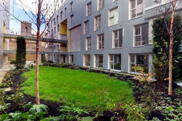Modern building with grassy courtyard and trees exterior at The Artisan in Dublin Student Accommodation