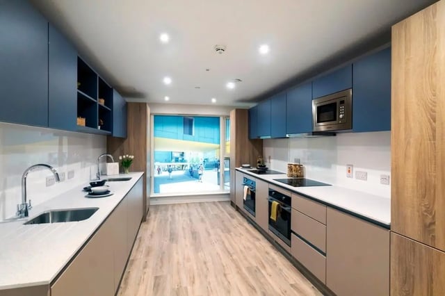Modern kitchen with blue cabinets sinks ovens microwave kitchen at The Artisan in Dublin Student Accommodation