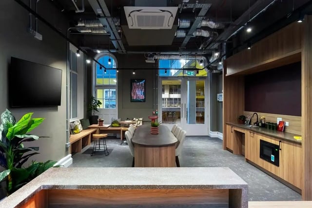 Modern communal kitchen with dining table and seating living room at The Artisan in Dublin Student Accommodation