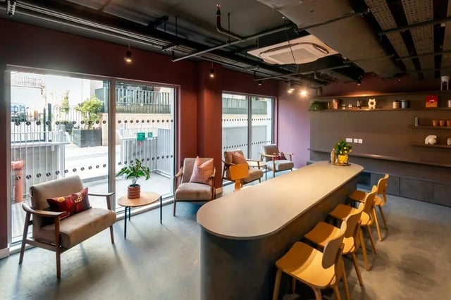 Seating area with long counter and chairs communal space at The Artisan in Dublin Student Accommodation