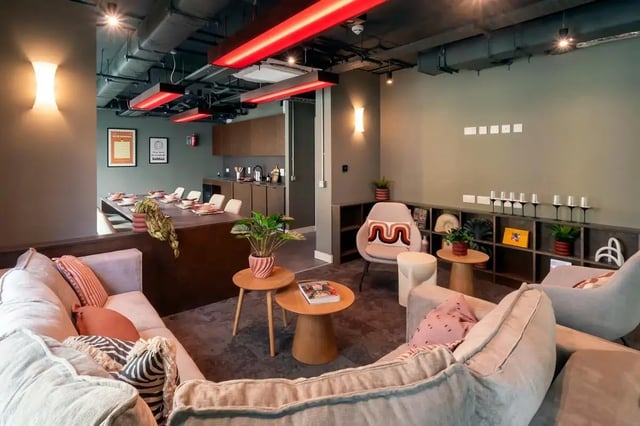 Sofa dining table chairs kitchen area lounge living room at The Artisan in Dublin Student Accommodation