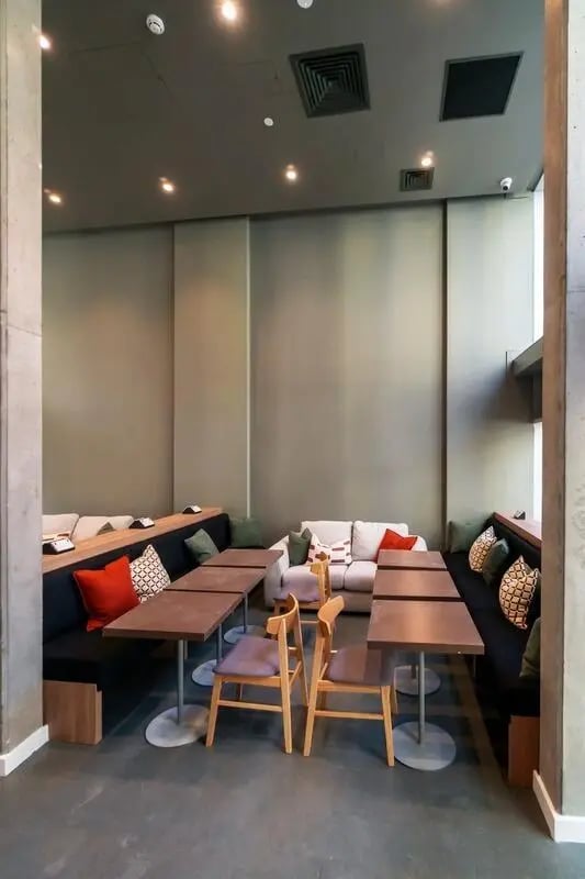 Sofa booths tables chairs and cushions communal area at The Artisan in Dublin Student Accommodation