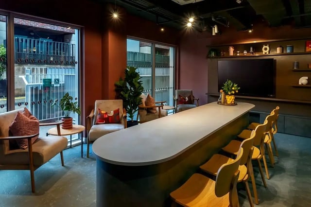 Modern communal area with seating and long table Living room at The Artisan in Dublin Student Accommodation