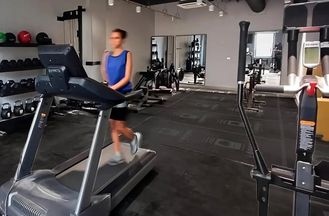 Woman on treadmill in gym with exercise equipment gym at Bradbury Place in Belfast Student Accommodation