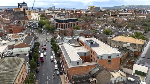 Modern building with cars and city view exterior at Bradbury Place in Belfast Student Accommodation