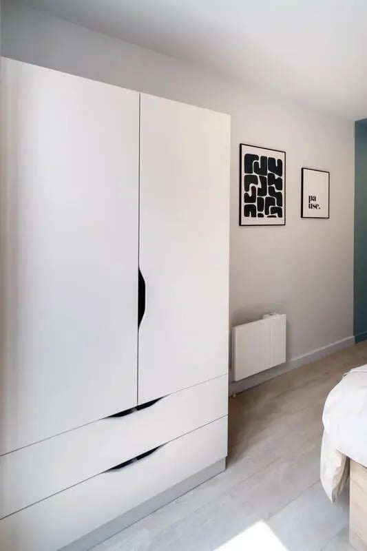 White wardrobe with artwork above bedroom at Stoneybatter Place in Dublin Student Accommodation