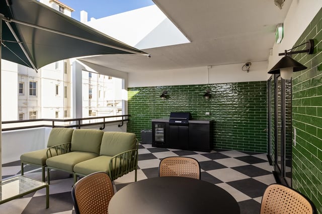 Sofa grill black cabinets outdoor dining patio area at UKO Potts Point in Sydney Student Accommodation