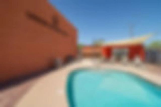 Pool with lounge area and building exterior at Union on Bellevue in Tucson Student Accommodation