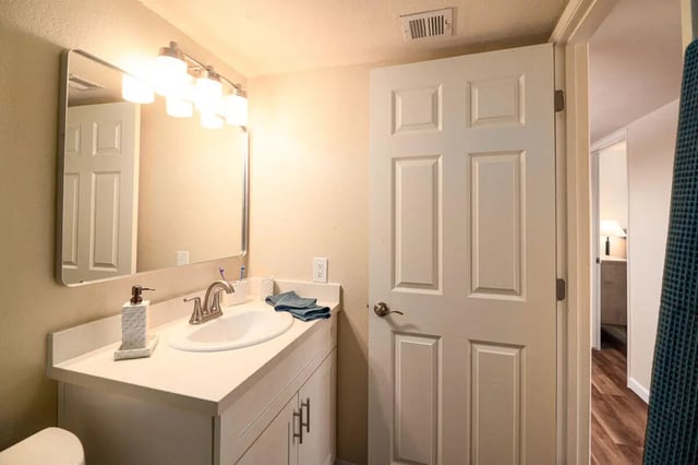 Vanity mirror sink and soap dispenser Bathroom at Union on Bellevue in Tucson Student Accommodation