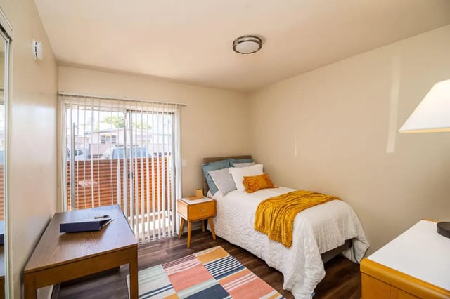 Bed desk nightstand blinds carpet bedroom at Union on Bellevue in Tucson Student Accommodation
