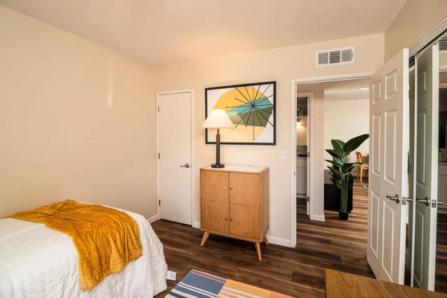 Bed with yellow blanket cabinet and art bedroom at Union on Bellevue in Tucson Student Accommodation