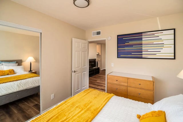 Bed dresser artwork and doorway bedroom at Union on Bellevue in Tucson Student Accommodation