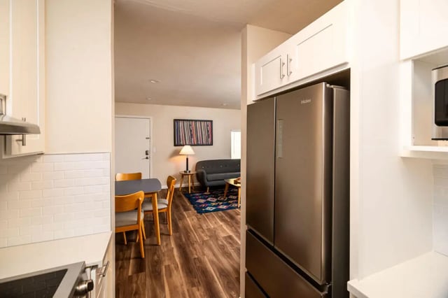 Stainless steel refrigerator and dining table area living room at Union on Bellevue in Tucson Student Accommodation