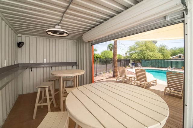 Tables chairs pool lounge chairs exterior at Union on Bellevue in Tucson Student Accommodation