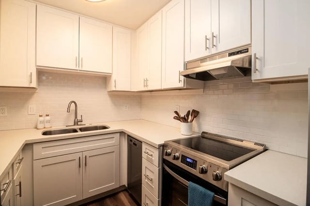 White cabinets sink stove and subway tile kitchen at Union on Bellevue in Tucson Student Accommodation