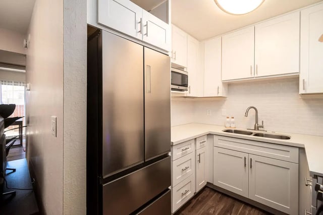 Stainless steel refrigerator white cabinets sink kitchen at Union on Bellevue in Tucson Student Accommodation