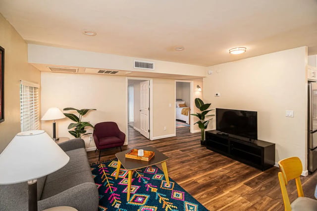 Living room with couch TV and coffee table living room at Union on Bellevue in Tucson Student Accommodation