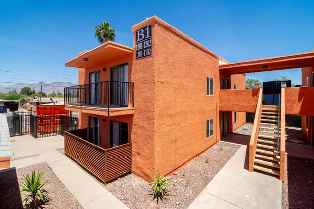 Orange stucco building with balconies stairs exterior at Union on Bellevue in Tucson Student Accommodation