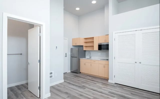 Kitchen area with refrigerator microwave and cabinets kitchen at Ace Apartments in Seattle Student Accommodation