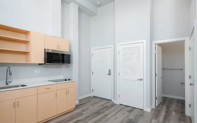 Kitchen area with cabinets microwave and sink kitchen at Ace Apartments in Seattle Student Accommodation