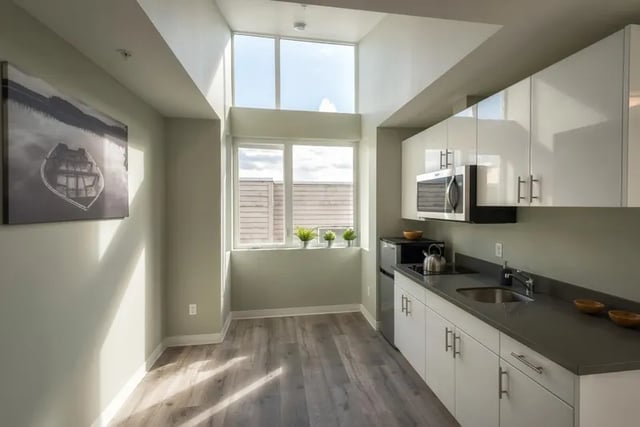 Modern kitchen with white cabinets and microwave kitchen at Ace Apartments in Seattle Student Accommodation