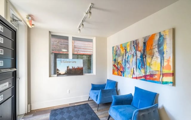 Two blue chairs large abstract painting entryway area at Ace Apartments in Seattle Student Accommodation