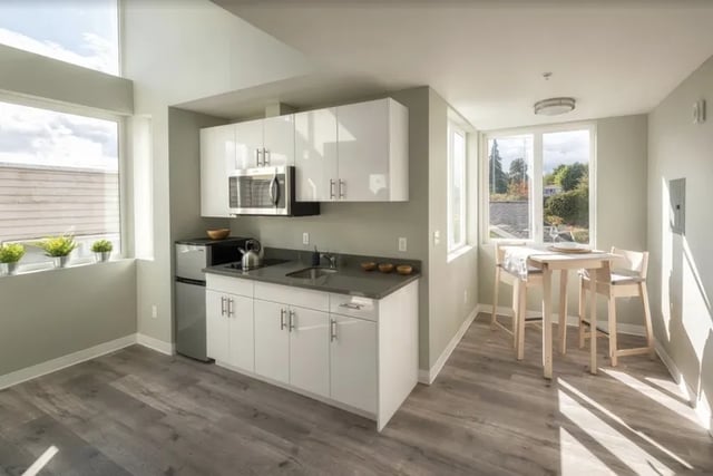 Modern kitchen and dining area with table and chairs kitchen at Ace Apartments in Seattle Student Accommodation