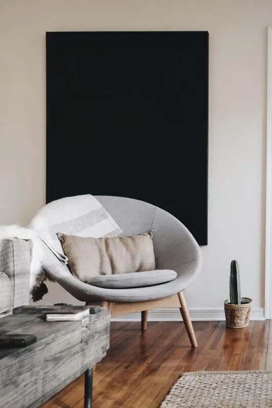 Gray chair with pillows and blanket living room at Storrs Student Living