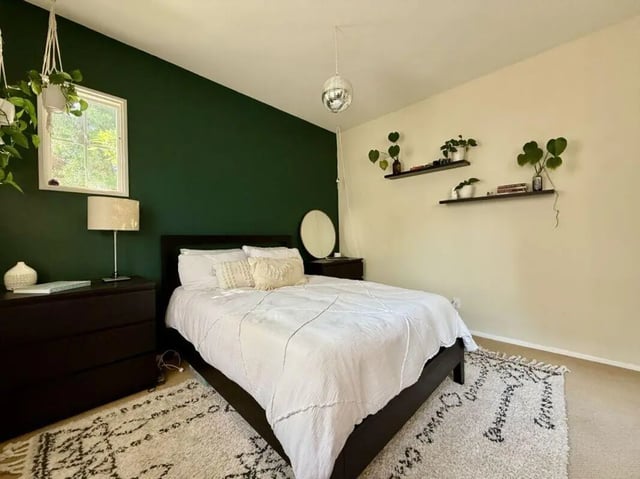 Dark dresser white bed patterned rug bedroom at Universal Student Housing in Los Angeles Student Accommodation