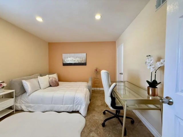 Bed desk chair and orchid bedroom study area at Universal Student Housing in Los Angeles Student Accommodation