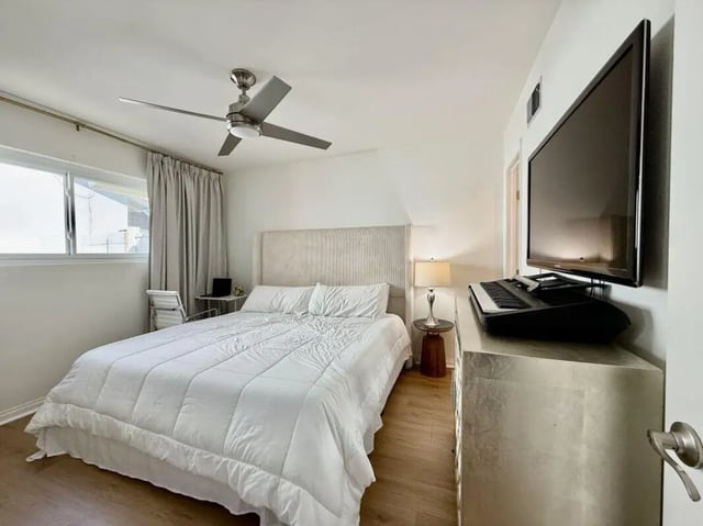 Bed fan TV keyboard dresser lamp bedroom at Universal Student Housing in Los Angeles Student Accommodation