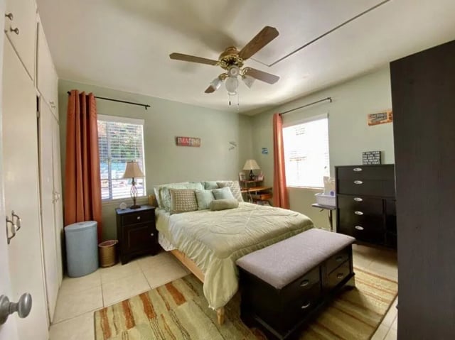 Bed with green linens dresser and wardrobe Bedroom at Universal Student Housing in Los Angeles Student Accommodation