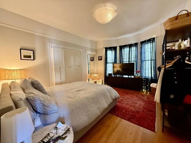 Bed with striped covers tv wardrobe Bedroom at Universal Student Housing in Los Angeles Student Accommodation