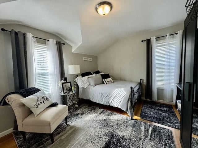 Bed with decorative pillows and armchair bedroom at Universal Student Housing in Los Angeles Student Accommodation