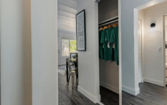 Green shirts hanging in closet with artwork study area at Victory East Lansing in East Lansing Student Accommodation
