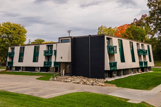 Modern apartment building with green balconies exterior at Victory East Lansing in East Lansing Student Accommodation