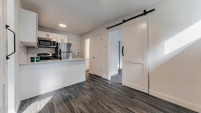 Modern kitchen with stainless steel appliances and sliding door kitchen at Victory East Lansing in East Lansing Student Accommodation