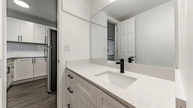 White vanity black faucet modern bathroom and kitchen exterior at Victory East Lansing in East Lansing Student Accommodation