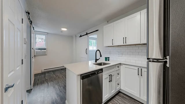 Modern kitchen with island stainless steel appliances and cabinets Kitchen at Victory East Lansing in East Lansing Student Accommodation