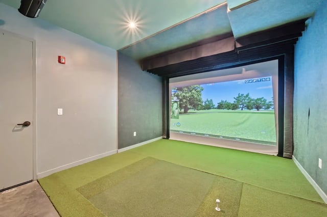 Golf simulator with putting green playing area at The Villas at San Gabriel in Austin Student Accommodation