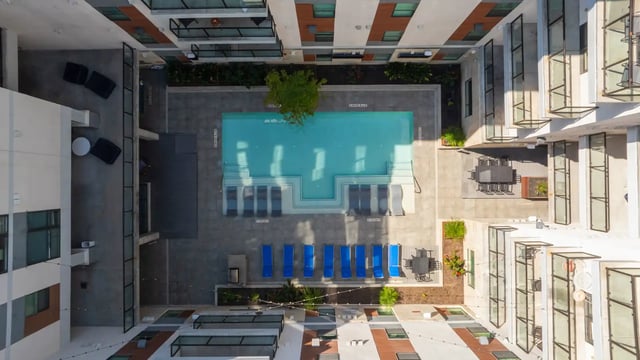 Swimming pool with loungers and seating area exterior at The Villas at San Gabriel in Austin Student Accommodation