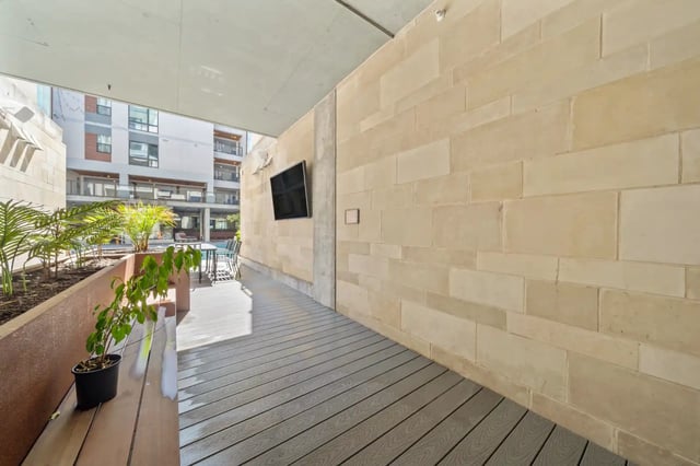 Bench plants and outdoor TV area exterior at The Villas at San Gabriel in Austin Student Accommodation
