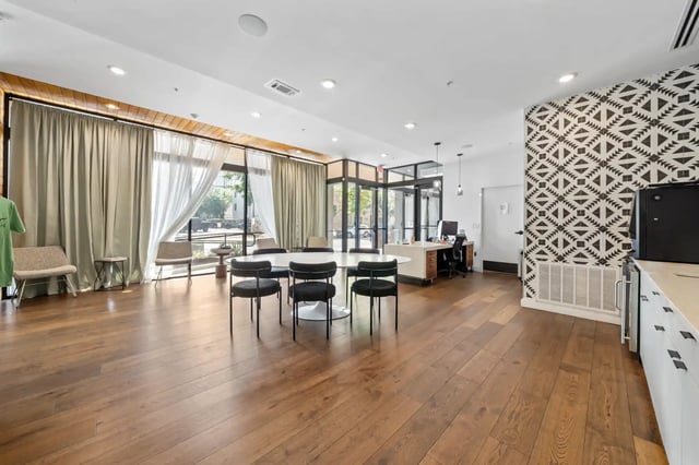 White table chairs reception desk patterned wall communal area at The Villas at San Gabriel in Austin Student Accommodation