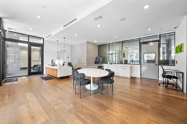 Reception desk round table chairs study desk common area at The Villas at San Gabriel in Austin Student Accommodation