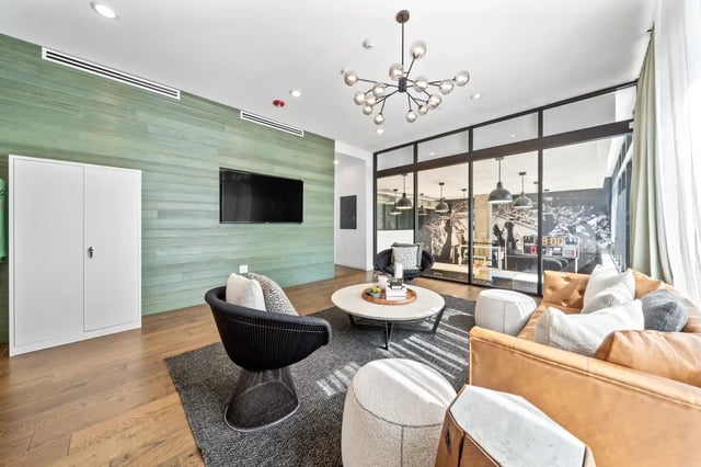 Modern seating area with leather couch living room at The Villas at San Gabriel in Austin Student Accommodation