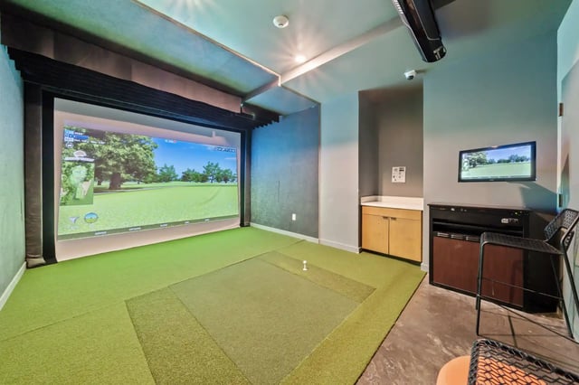 Golf simulator screen artificial turf and TV entertainment Image at The Villas at San Gabriel in Austin Student Accommodation